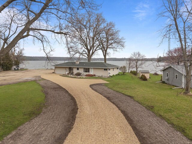 W2138 Melmar Dr, Markesan, WI 53946 - view of yard with driveway, a water view, and a garage