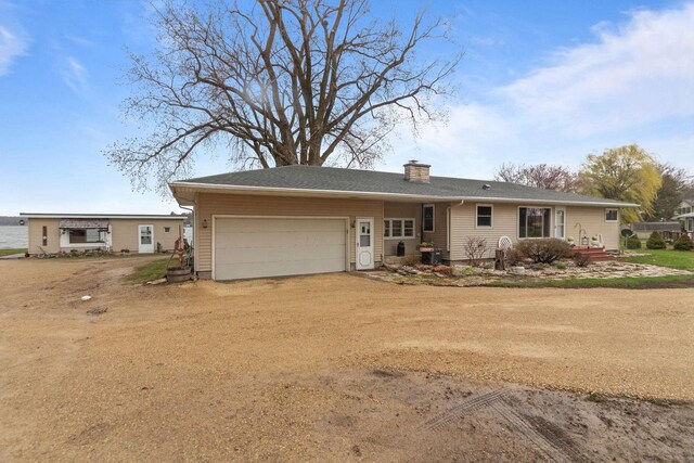 W2138 Melmar Dr, Markesan, WI 53946 - ranch-style home featuring a garage, a chimney, and dirt driveway