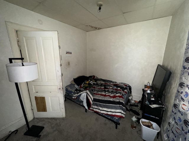 carpeted bedroom with a drop ceiling