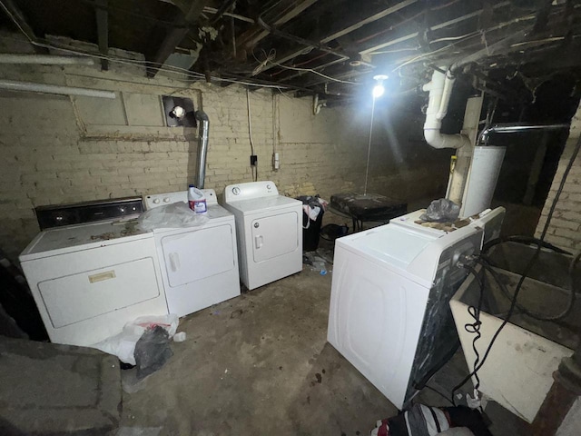 laundry room featuring water heater, washer and clothes dryer, and laundry area