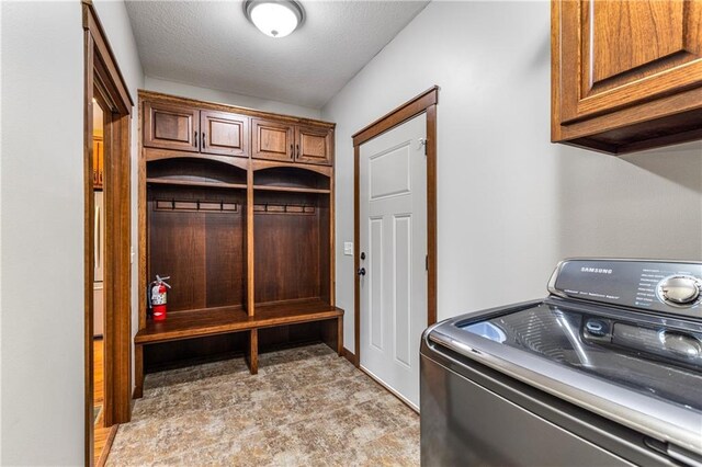 washroom featuring washer / clothes dryer and cabinet space