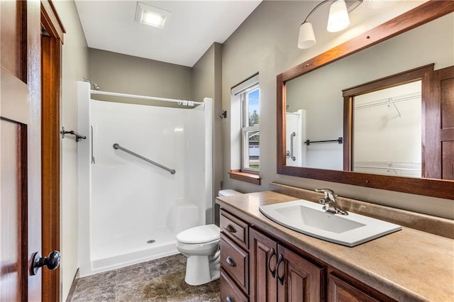 full bathroom featuring a shower, toilet, and vanity