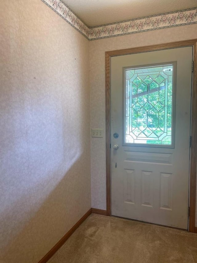 doorway with carpet flooring
