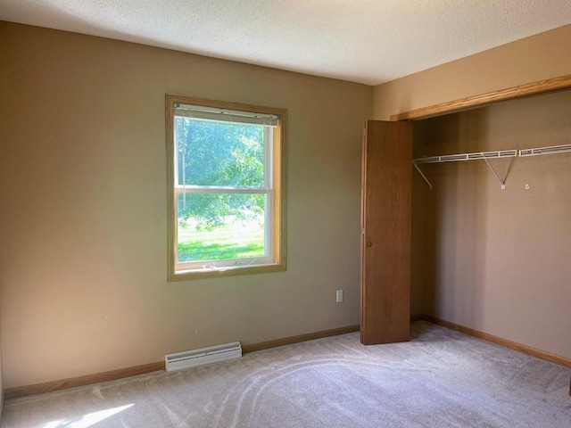 unfurnished bedroom with a closet, carpet flooring, baseboards, visible vents, and a textured ceiling