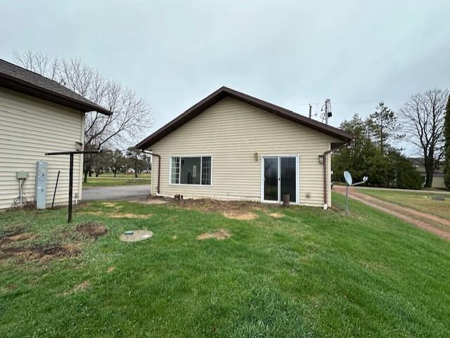 rear view of house with a yard
