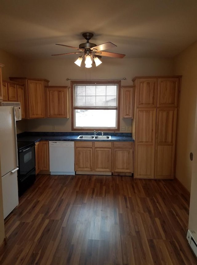 kitchen with dark wood-style flooring, ceiling fan, white appliances, and a sink