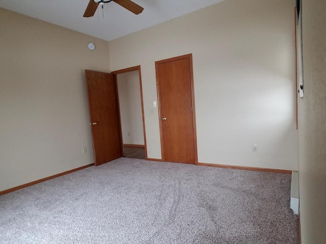 empty room featuring baseboards, a ceiling fan, and carpet flooring