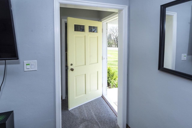 doorway with dark carpet