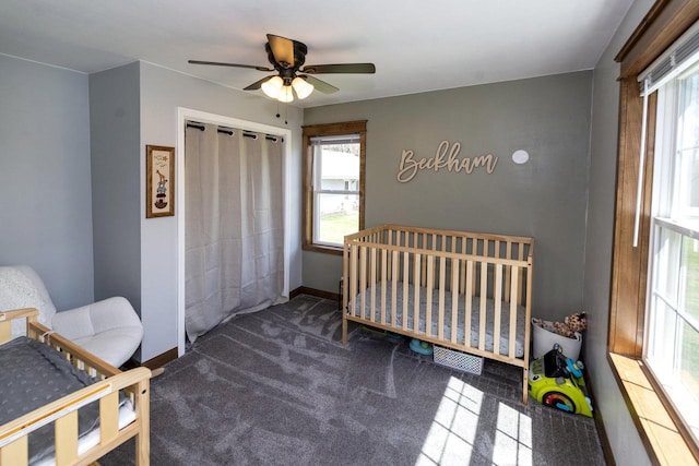 bedroom featuring carpet floors, a closet, baseboards, and multiple windows