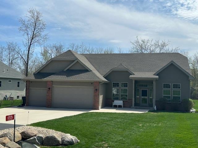 ranch-style home featuring brick siding, a garage, a front lawn, and driveway