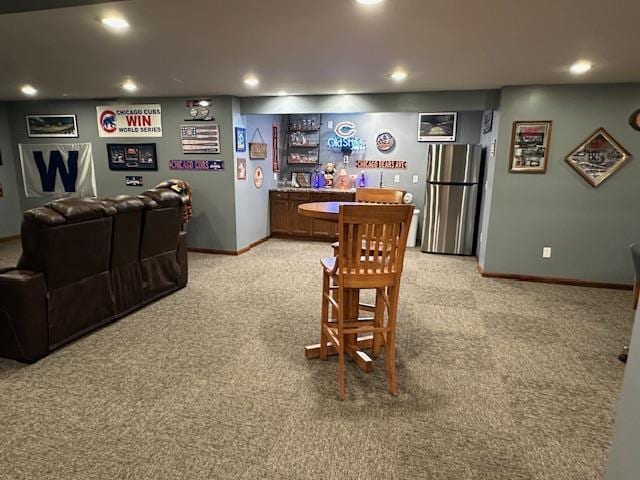 interior space with light colored carpet, recessed lighting, bar, and baseboards