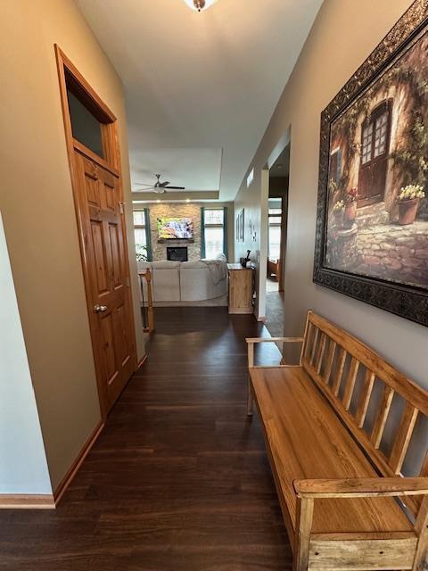 corridor featuring dark wood finished floors