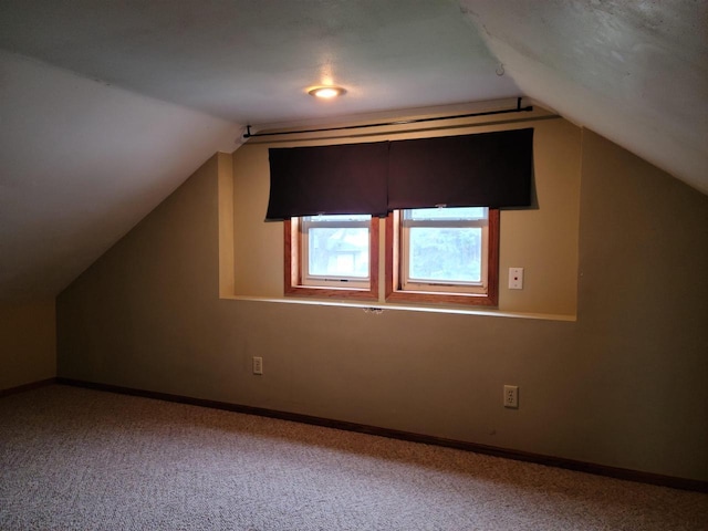 bonus room featuring baseboards, lofted ceiling, and carpet floors