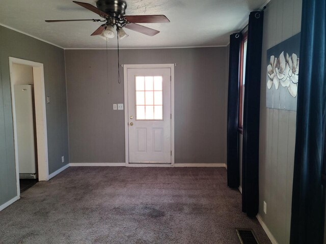 interior space with crown molding, visible vents, ceiling fan, and baseboards