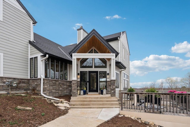 5400 N State Road 83, Hartland, WI 53029 - view of front of home featuring a chimney, a shingled roof, and stone siding