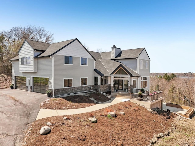 5400 N State Road 83, Hartland, WI 53029 - view of front of house with an attached garage, aphalt driveway, roof with shingles, and a chimney