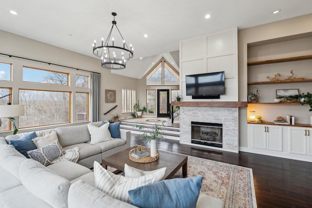 5400 N State Road 83, Hartland, WI 53029 - living room featuring dark wood-style flooring, lofted ceiling, a fireplace, recessed lighting, and a notable chandelier