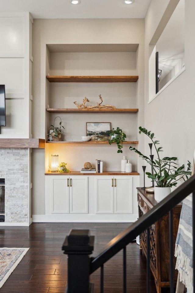 5400 N State Road 83, Hartland, WI 53029 - bar featuring recessed lighting, a stone fireplace, built in shelves, and dark wood-type flooring