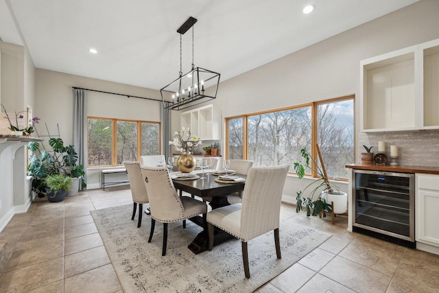 5400 N State Road 83, Hartland, WI 53029 - dining room featuring light tile patterned flooring, beverage cooler, a chandelier, recessed lighting, and baseboards