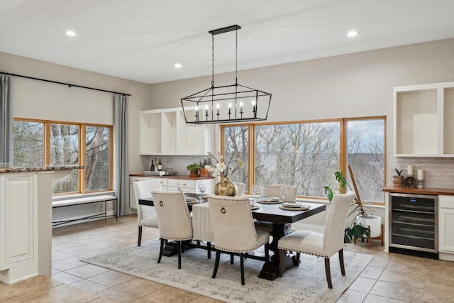 5400 N State Road 83, Hartland, WI 53029 - dining space featuring beverage cooler, a chandelier, recessed lighting, and light tile patterned flooring