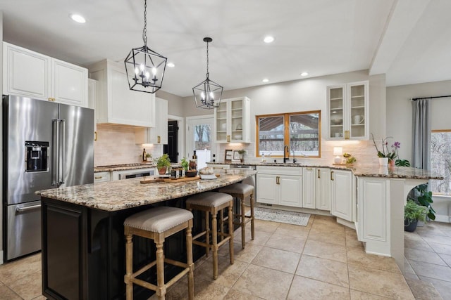 5400 N State Road 83, Hartland, WI 53029 - kitchen with a sink, backsplash, a chandelier, and stainless steel appliances