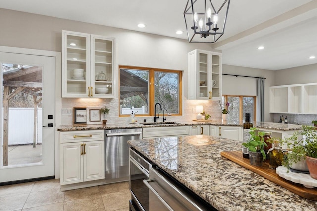 5400 N State Road 83, Hartland, WI 53029 - kitchen with a sink, light stone counters, plenty of natural light, and stainless steel dishwasher