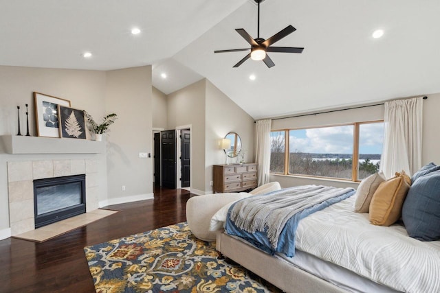 5400 N State Road 83, Hartland, WI 53029 - bedroom with high vaulted ceiling, recessed lighting, baseboards, wood finished floors, and a tile fireplace