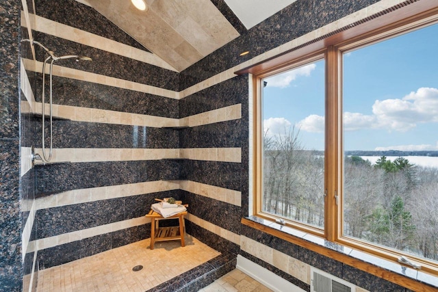 5400 N State Road 83, Hartland, WI 53029 - full bath featuring a water view, visible vents, a tile shower, and vaulted ceiling
