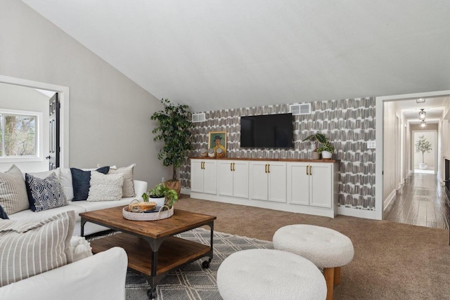 5400 N State Road 83, Hartland, WI 53029 - living area with visible vents, lofted ceiling, an accent wall, and wallpapered walls