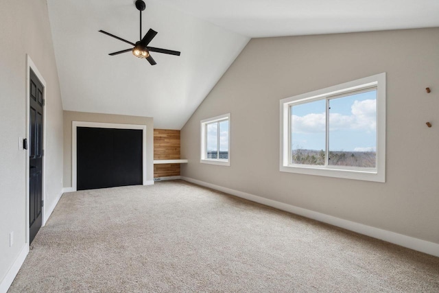 5400 N State Road 83, Hartland, WI 53029 - unfurnished living room featuring baseboards, a ceiling fan, carpet flooring, and lofted ceiling
