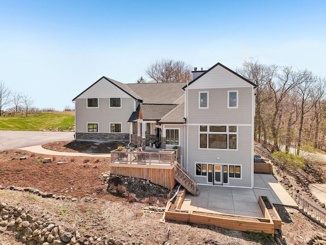 5400 N State Road 83, Hartland, WI 53029 - rear view of property featuring a wooden deck, stairs, and a patio area