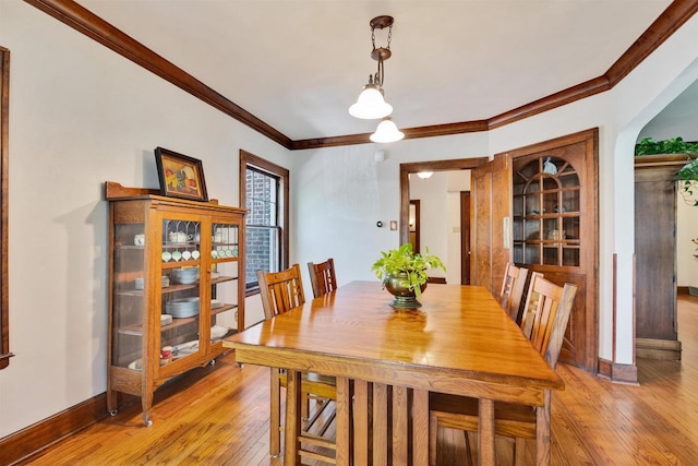 172 N St, Sun Prairie, WI 53590 - dining area with light wood-type flooring, crown molding, and baseboards