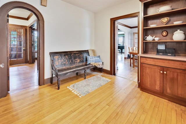 172 N St, Sun Prairie, WI 53590 - corridor with arched walkways, light wood-style floors, baseboards, and ornamental molding