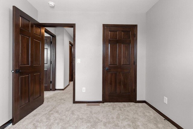 433 Scott St, Ripon, WI 54971 - unfurnished bedroom featuring baseboards and light carpet