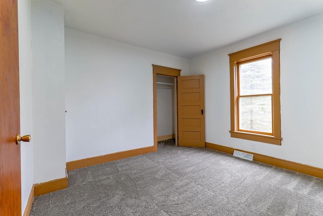 unfurnished bedroom with baseboards, visible vents, and carpet flooring