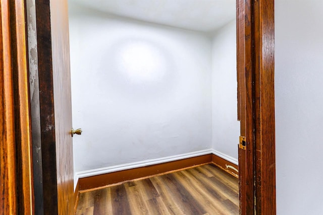 unfurnished room featuring wood finished floors and baseboards