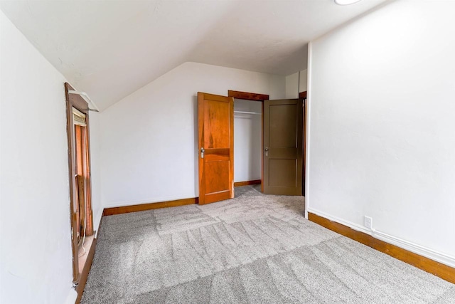 bonus room with baseboards, carpet flooring, and lofted ceiling