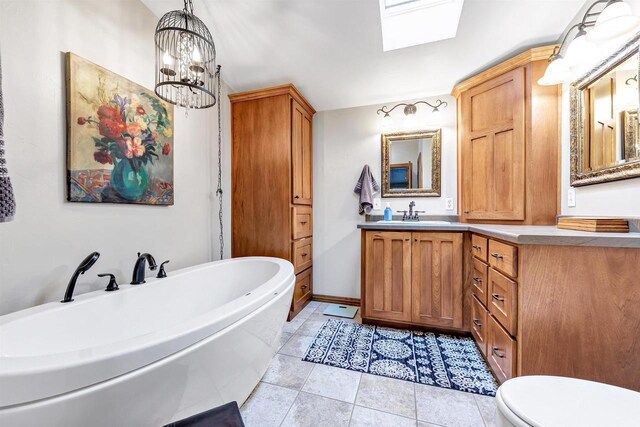 8795 County Rd S, Pulaski, WI 54162 - full bathroom with tile patterned flooring, vanity, a freestanding tub, toilet, and a skylight