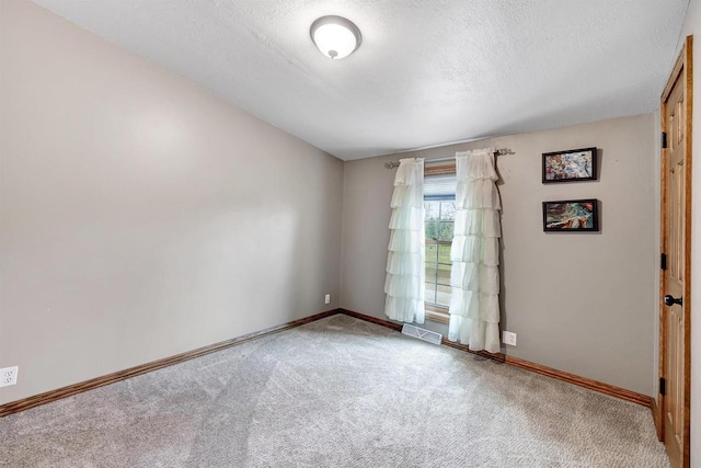 8795 County Rd S, Pulaski, WI 54162 - carpeted empty room with a textured ceiling, visible vents, and baseboards