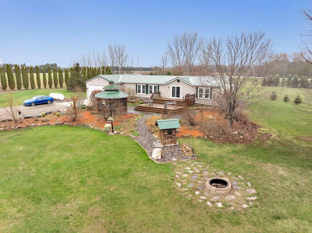 8795 County Rd S, Pulaski, WI 54162 - view of front of house featuring a front yard, a wooden deck, a gazebo, and an outdoor fire pit