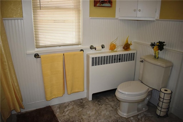 903 Wilson Ave, Rice Lake, WI 54868 - bathroom with radiator heating unit, wainscoting, and toilet