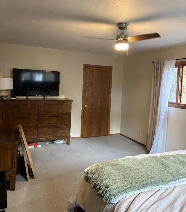 W4609 S Pearl Lake Rd, Redgranite, WI 54970 - bedroom with light carpet, baseboards, and ceiling fan