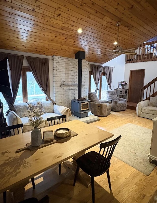 W4609 S Pearl Lake Rd, Redgranite, WI 54970 - dining area featuring a wood stove, wood ceiling, plenty of natural light, and wood finished floors