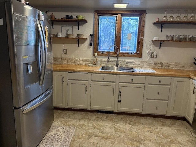 W4609 S Pearl Lake Rd, Redgranite, WI 54970 - kitchen featuring stainless steel refrigerator with ice dispenser, a sink, open shelves, and butcher block countertops