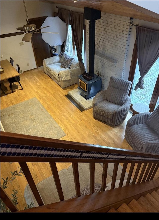 W4609 S Pearl Lake Rd, Redgranite, WI 54970 - living room with a wood stove, wood finished floors, and a ceiling fan