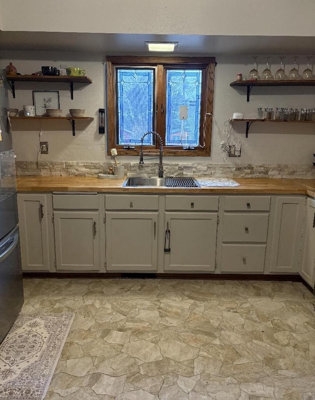 W4609 S Pearl Lake Rd, Redgranite, WI 54970 - kitchen with a sink, butcher block counters, light stone finish flooring, and open shelves