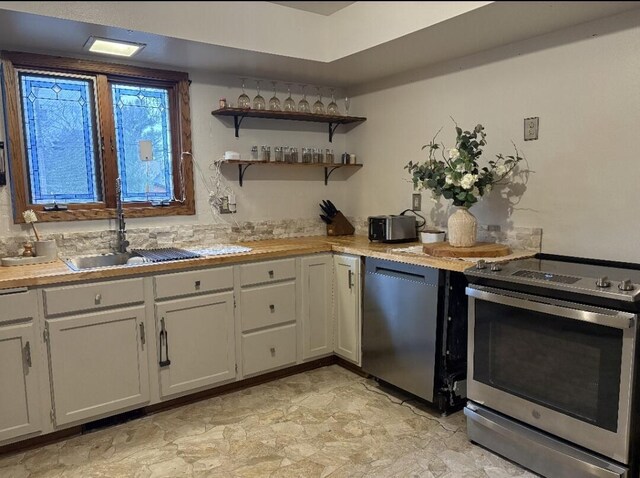 W4609 S Pearl Lake Rd, Redgranite, WI 54970 - kitchen featuring stainless steel electric range oven, dishwashing machine, a sink, and light countertops