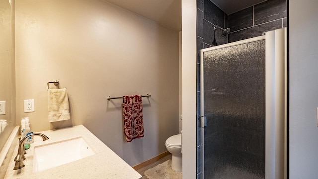 bathroom featuring a stall shower, vanity, and toilet