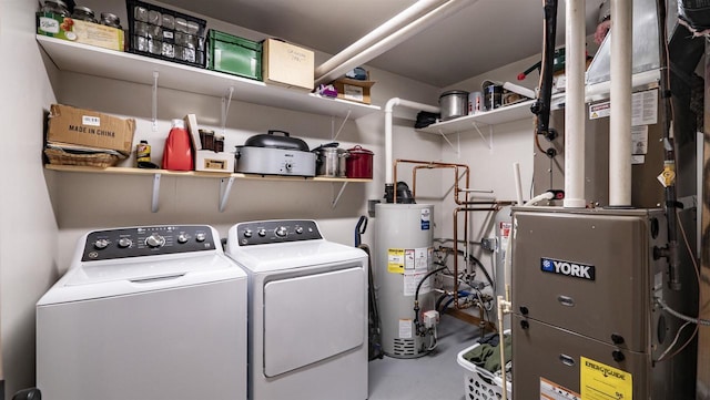 laundry room with washer and dryer, laundry area, heating unit, and gas water heater