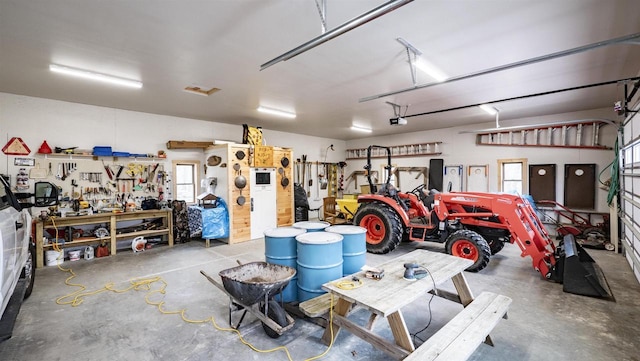 garage with a workshop area and a garage door opener